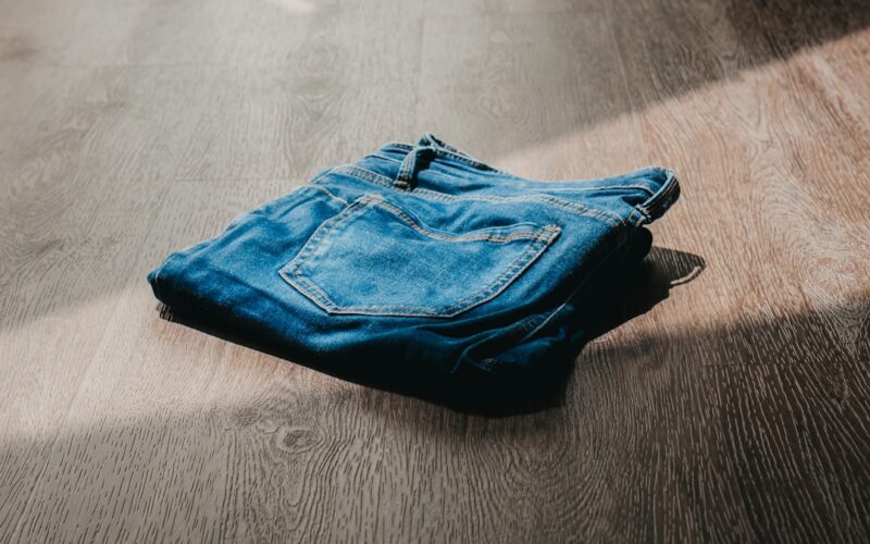 Jeans on the floor with sun ray shining through window 1